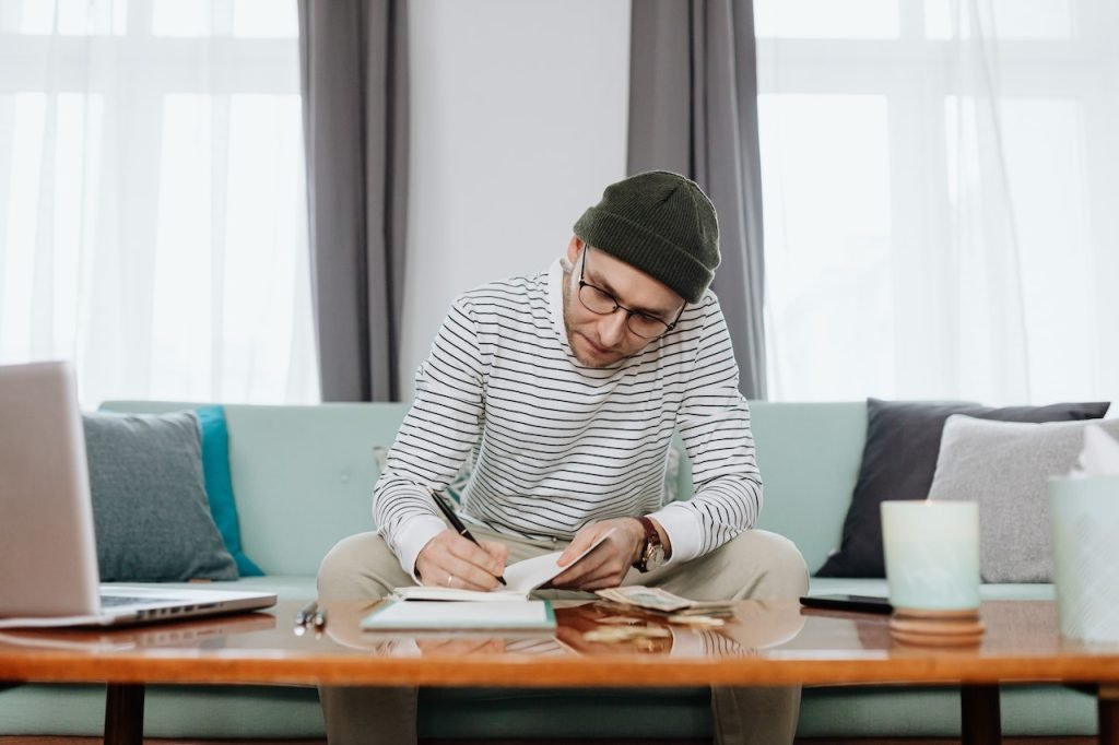 person sitting on lounge working through finances